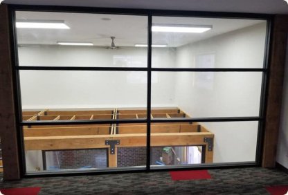 Interior black-framed glass partition wall in an office build-out