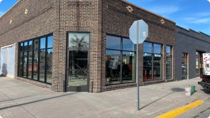 Brick retail building with a row of new storefront windows